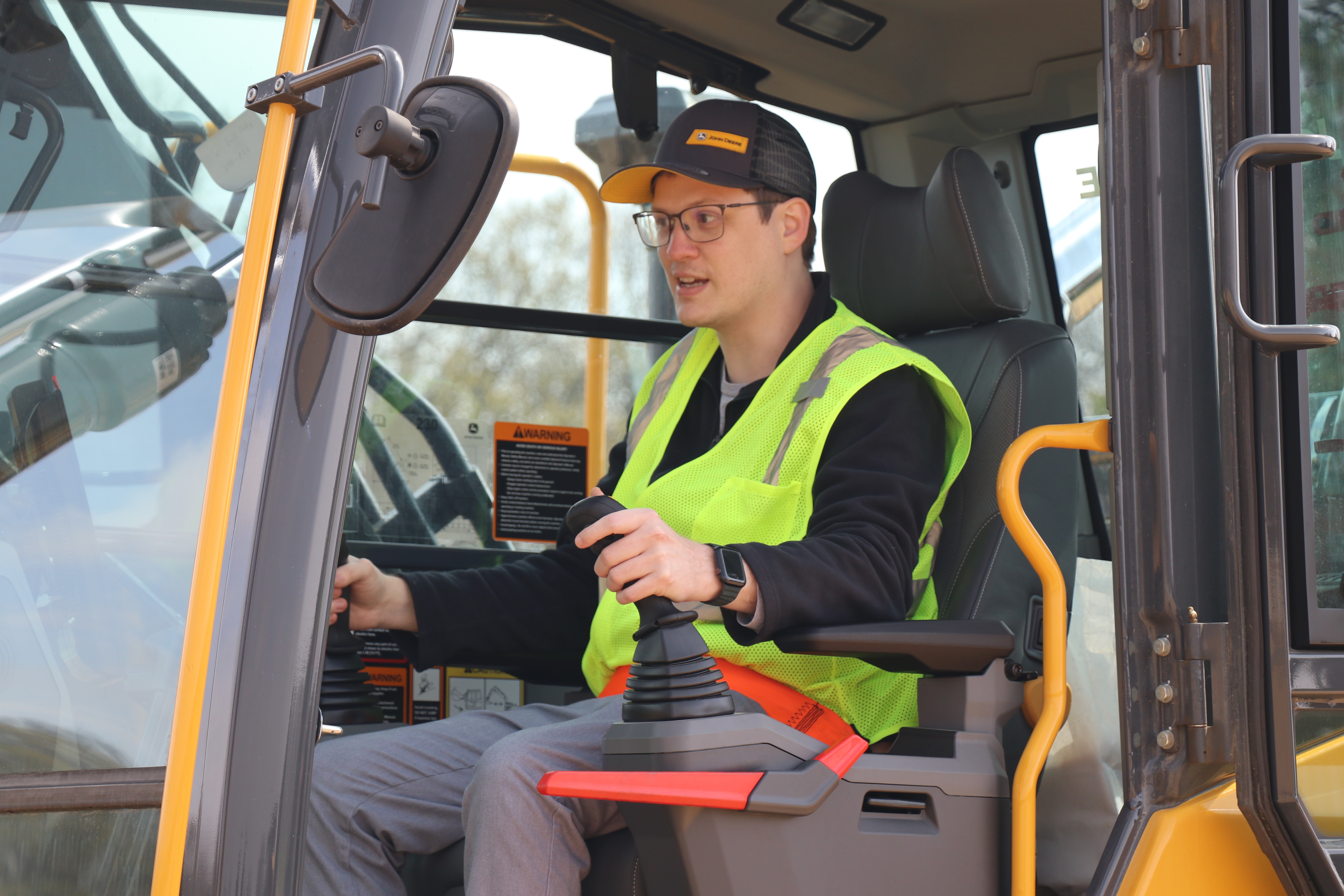 Excavator operator at dual joystick controls