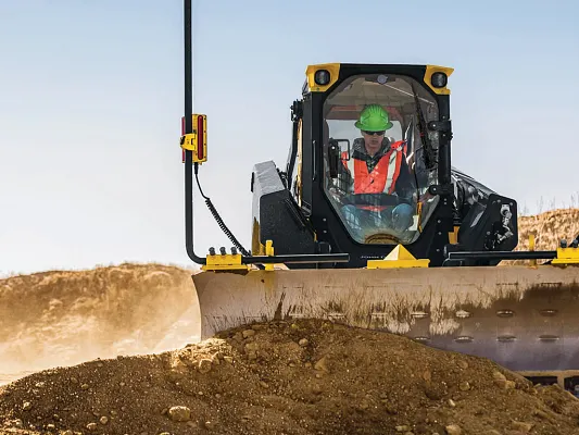 John Deere 333 P-Tier gallery — 333 P-Tier compact track loader moving a large mound of dirt around a jobsite